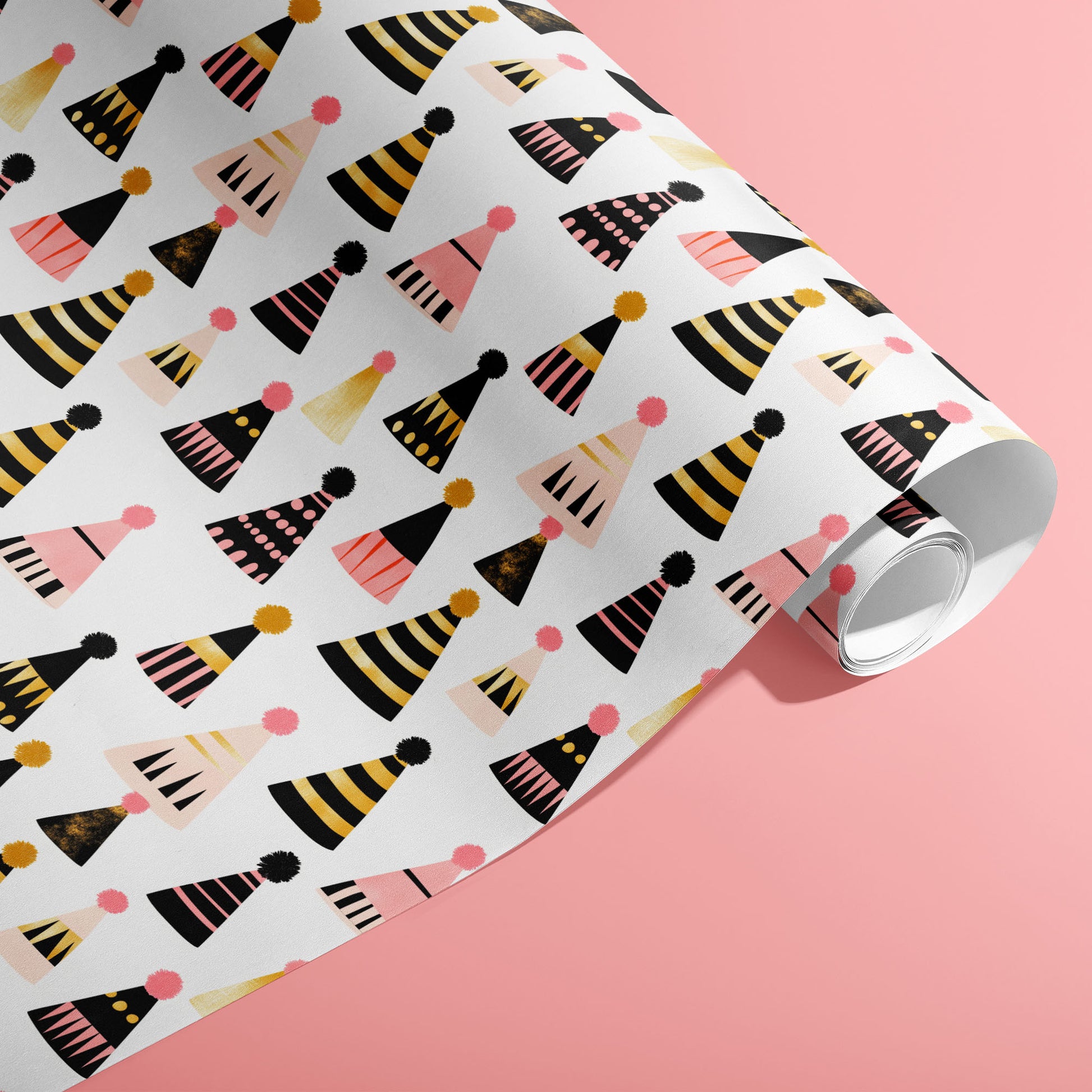 A partially unfurled roll of Party Hat Parade wrap showing playful patterned party hats on a bright pink background.