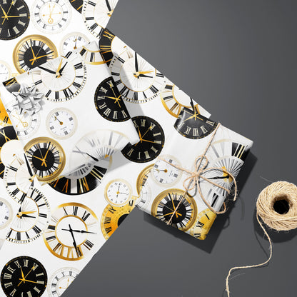 Two gifts wrapped in Luxe Time—one silver-bowed, one tied with twine—sit on two unused sheets beside a twine spool on a dark gray surface, with gold and black clock faces on white.
