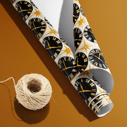 A partially unfurled Deco Century roll with the white underside beside a spool of natural twine shows black clock faces and gold starbursts on pearl white over a golden mustard background.