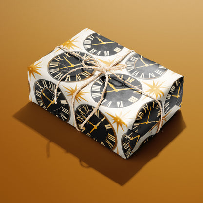 A rectangular gift wrapped in Deco Century paper and tied with natural twine features black clock faces and gold starbursts on pearl white against a golden mustard background.