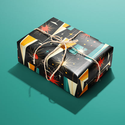 A single gift wrapped in Midcentury Starburst and tied with natural twine, displaying atomic starbursts, champagne flutes, and confetti in red, gold, and teal on black, set on a teal surface.