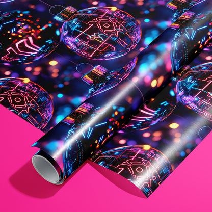 A roll of Chrome City Christmas rests on an unrolled sheet, showing chrome baubles with neon circuit lines and city lights on deep navy, styled on a hot pink surface.