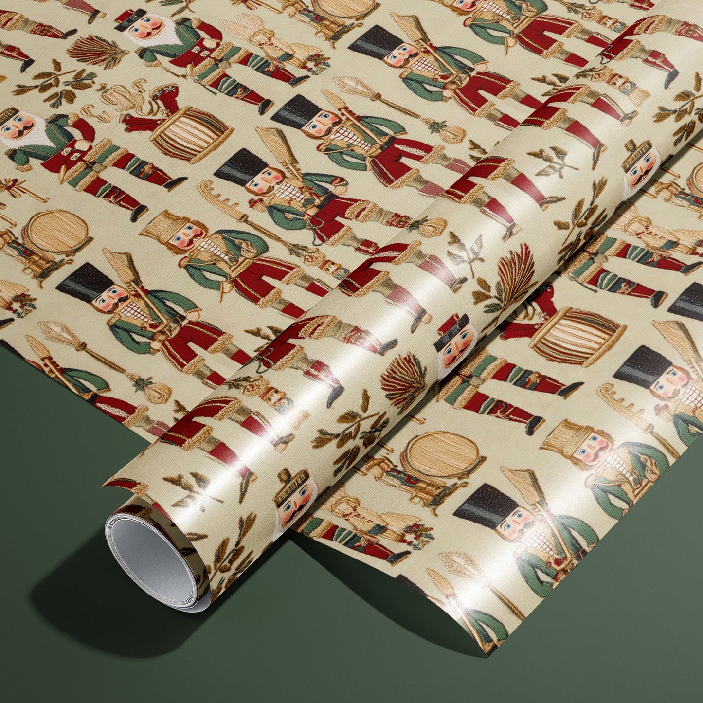 A roll of Heritage Nutcrackers rests on a matching unrolled sheet, showing vintage nutcracker soldiers, drums, and laurel sprigs on a cream ground on a deep green surface.