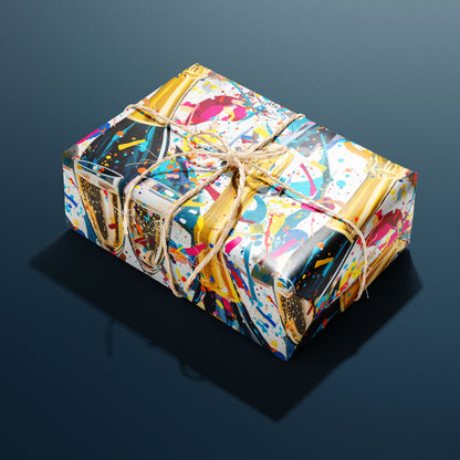 A rectangular gift wrapped in Glitter & Fizz paper and tied with natural twine displays champagne flutes, black champagne bottles, and glittering confetti, sitting on a charcoal gray background.
