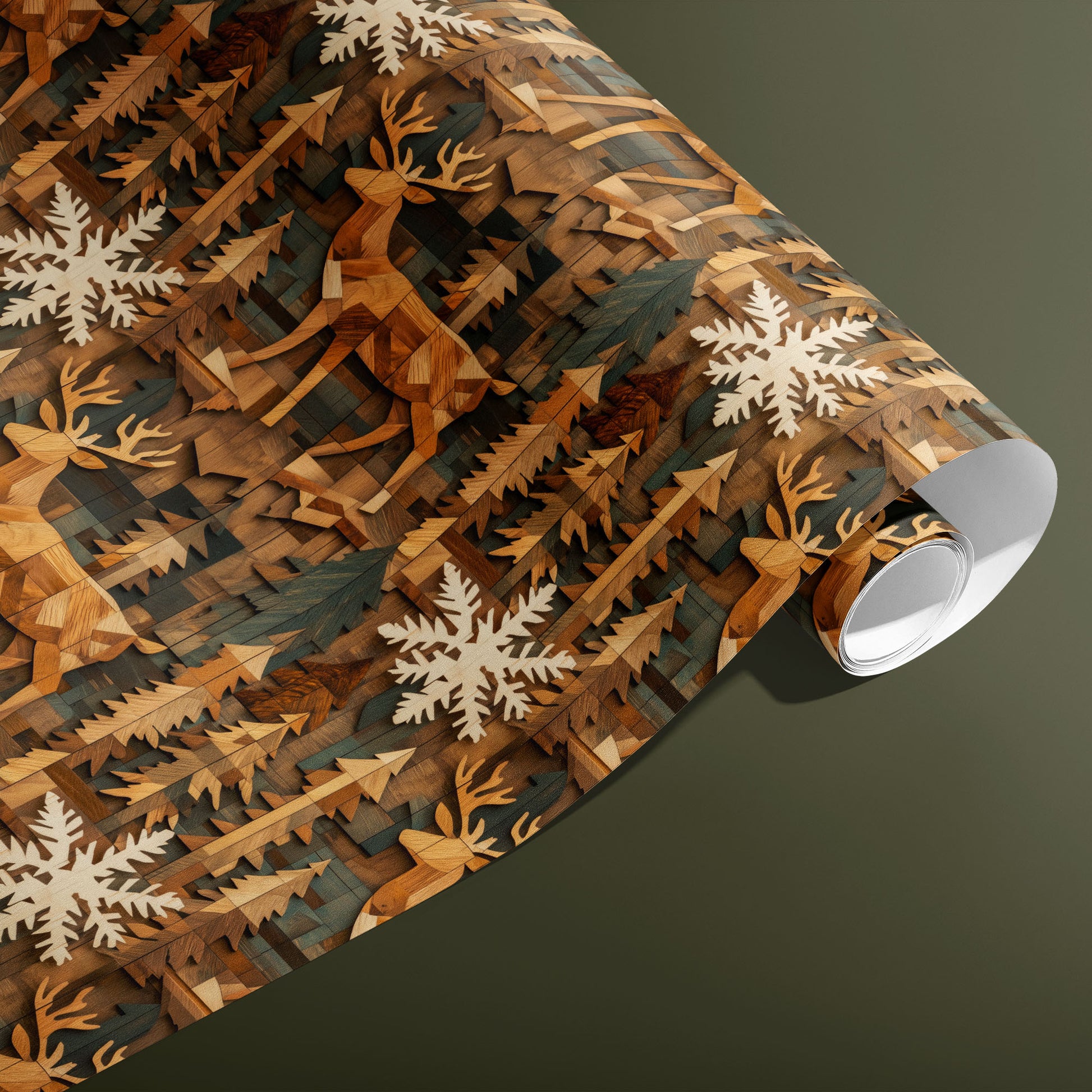 A partially unfurled roll of Timber Tapestry gift wrap shows marquetry-like deer, pine trees, and pale snowflakes in warm wood hues against an olive green background.