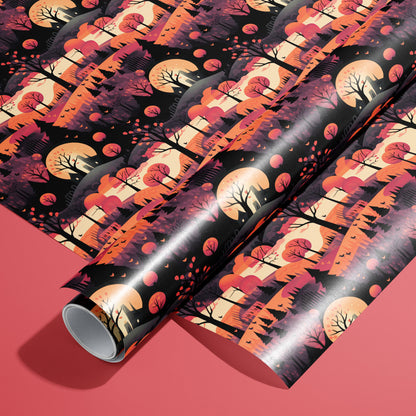 A roll of Halloween Landscape wrapping paper resting on a matching unrolled sheet, with moonlit trees, hills, and bats in warm oranges and blacks on a coral-red background.