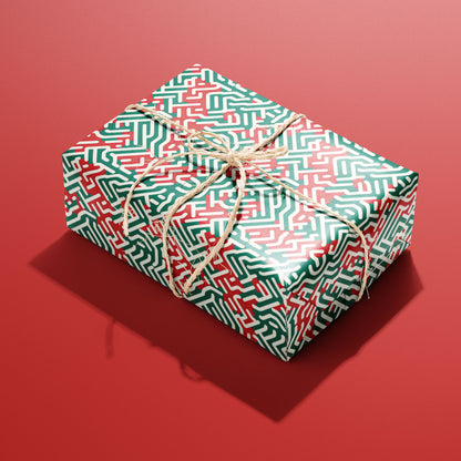 A single rectangular gift wrapped in Geometric Xmas paper tied with natural twine, its red, green, and white geometric maze pattern shining against a red background.