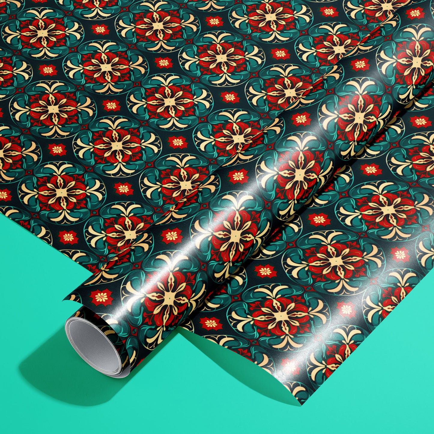 A roll of Arabesque Christmas wrapping paper on a matching unrolled sheet, with red, gold, and emerald arabesque medallions on deep navy, set on a bright teal background.