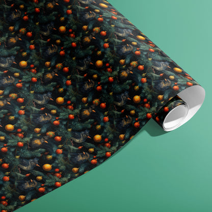 A partially unfurled roll of Birds in Boughs gift wrap displays painterly birds in pine branches with red and golden baubles, resting on a pale teal surface.