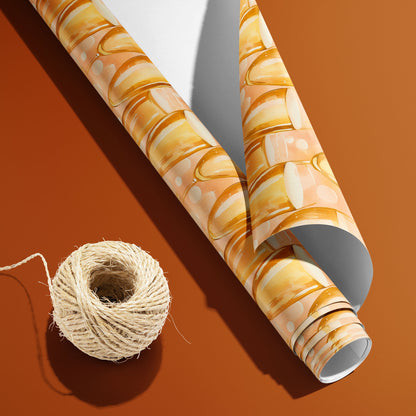 A partially unfurled Shimmering Sips roll with the white underside visible beside a spool of natural twine, featuring champagne flutes and bubbles on a copper-orange surface.