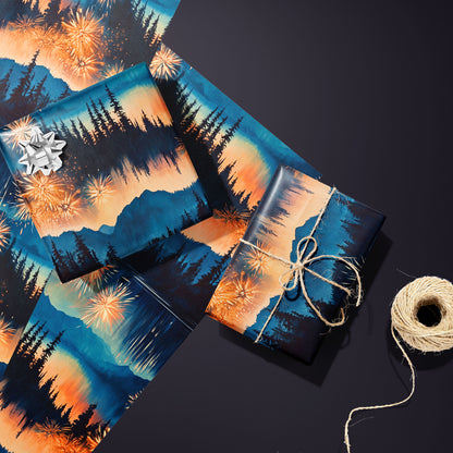 Two gifts in Radiant Reflections—one silver-bowed and one tied with twine—rest on two unused sheets showing fireworks and pine silhouettes beside a twine spool on a charcoal-purple surface.