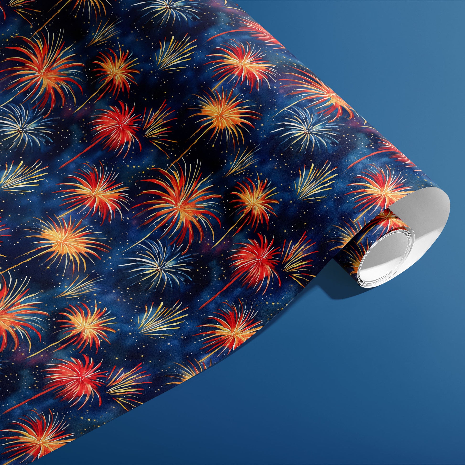 A partially unfurled roll of Blooming Sky paper showing hand-painted fireworks and tiny sparkles across a deep navy sky print, set against a steel-blue surface.