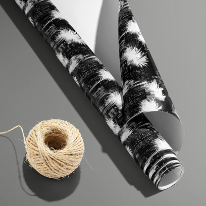 A partially unfurled Fireworks Fantasy roll with the white underside visible beside a spool of natural twine, featuring fireworks on a slate gray surface.