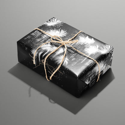 A single rectangular gift wrapped in Fireworks Fantasy paper—bright white fireworks bursts on black—tied with natural twine on a slate gray background.