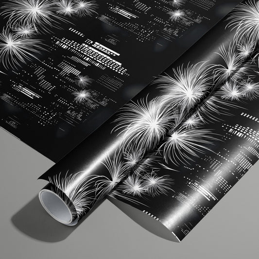 A roll of Skyline Magic wrapping paper on an unrolled sheet, showing a black-and-white city skyline with fireworks and geometric building lights, on a medium gray surface.
