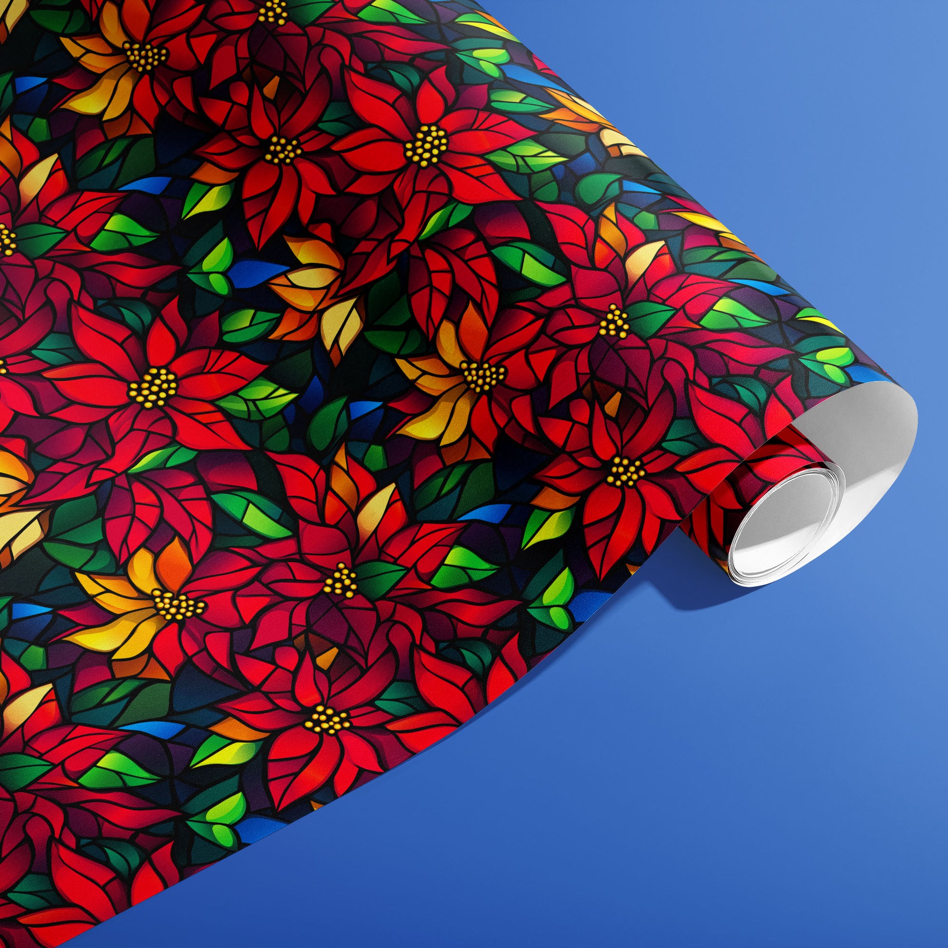 A partially unfurled roll of Poinsettia Prism featuring mosaic-style poinsettias and colorful leaves on black, resting on a cobalt-blue background.