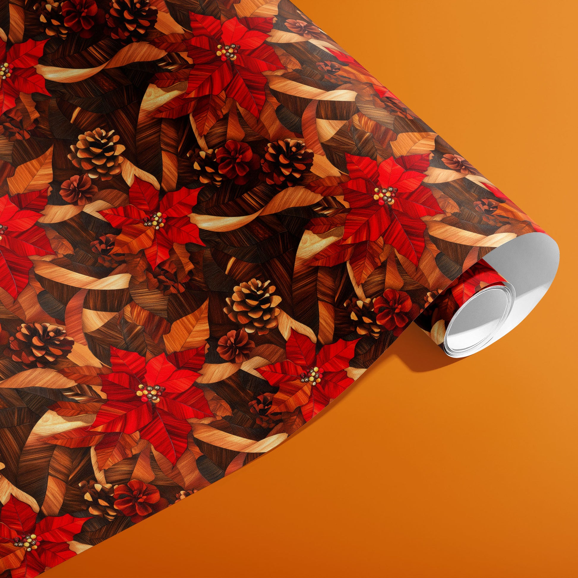 A partially unfurled roll of Cedar & Scarlet paper showing rich red poinsettias, layered cedar leaves, and pinecones against a warm orange backdrop.