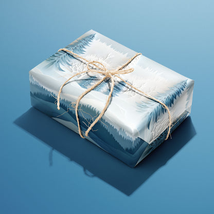 A single rectangular gift wrapped in Snowy Grove paper—layered snowy pines and delicate branches—tied with natural twine on a medium blue background.