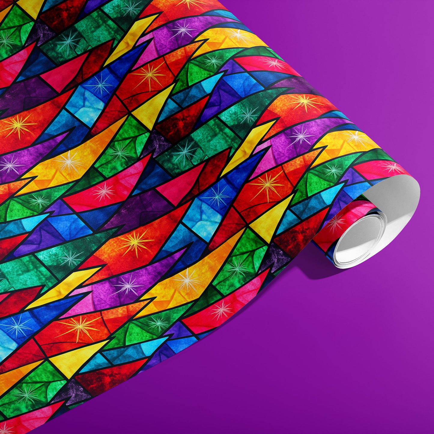 A partially unfurled roll of Prismatic Holiday wrapping paper featuring rainbow stained-glass facets and twinkling starbursts on a vibrant purple surface.