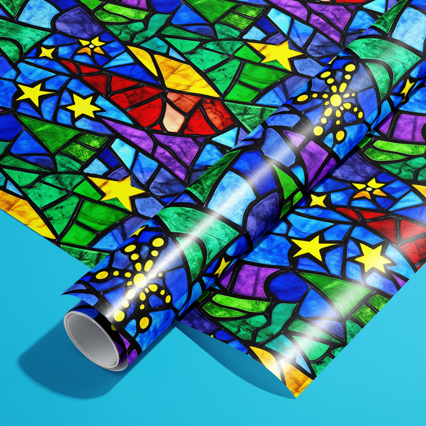 A roll of Starlit Holiday rests on an unrolled sheet, showing a stained-glass mosaic of stars and stylized trees in jewel tones with black lead lines on a bright cyan surface.