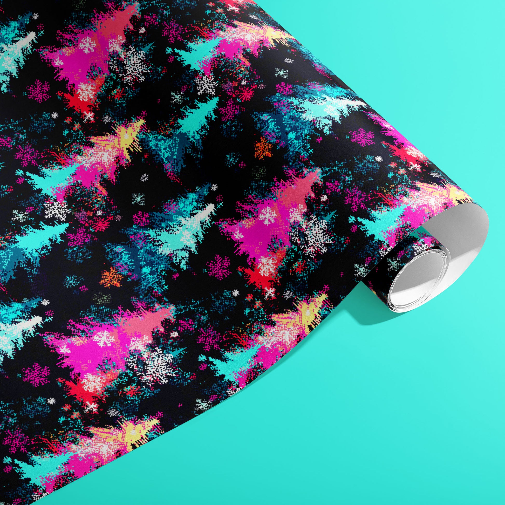 A partially unfurled roll of Pixel Pines wrapping paper with pixel-art pines, ornaments, and tiny snowflakes in bright holiday hues on a soft teal surface.