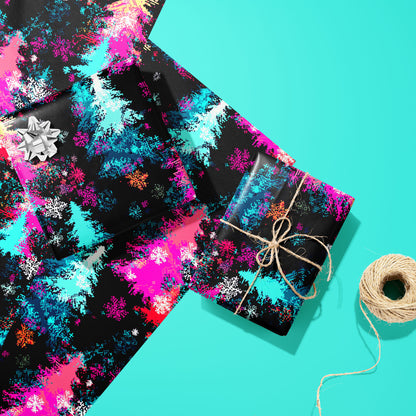 Two gifts wrapped in Pixel Pines—one with a silver bow and one tied with twine—rest on two unused sheets beside a twine spool on a soft teal surface with pixel-art pines and snowflakes.