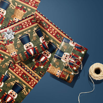 Two Regal Nutcrackers gifts—one with a silver bow and one tied with twine—rest on two unused sheets beside a twine spool on a deep steel blue surface, showing nutcrackers and holly bands.