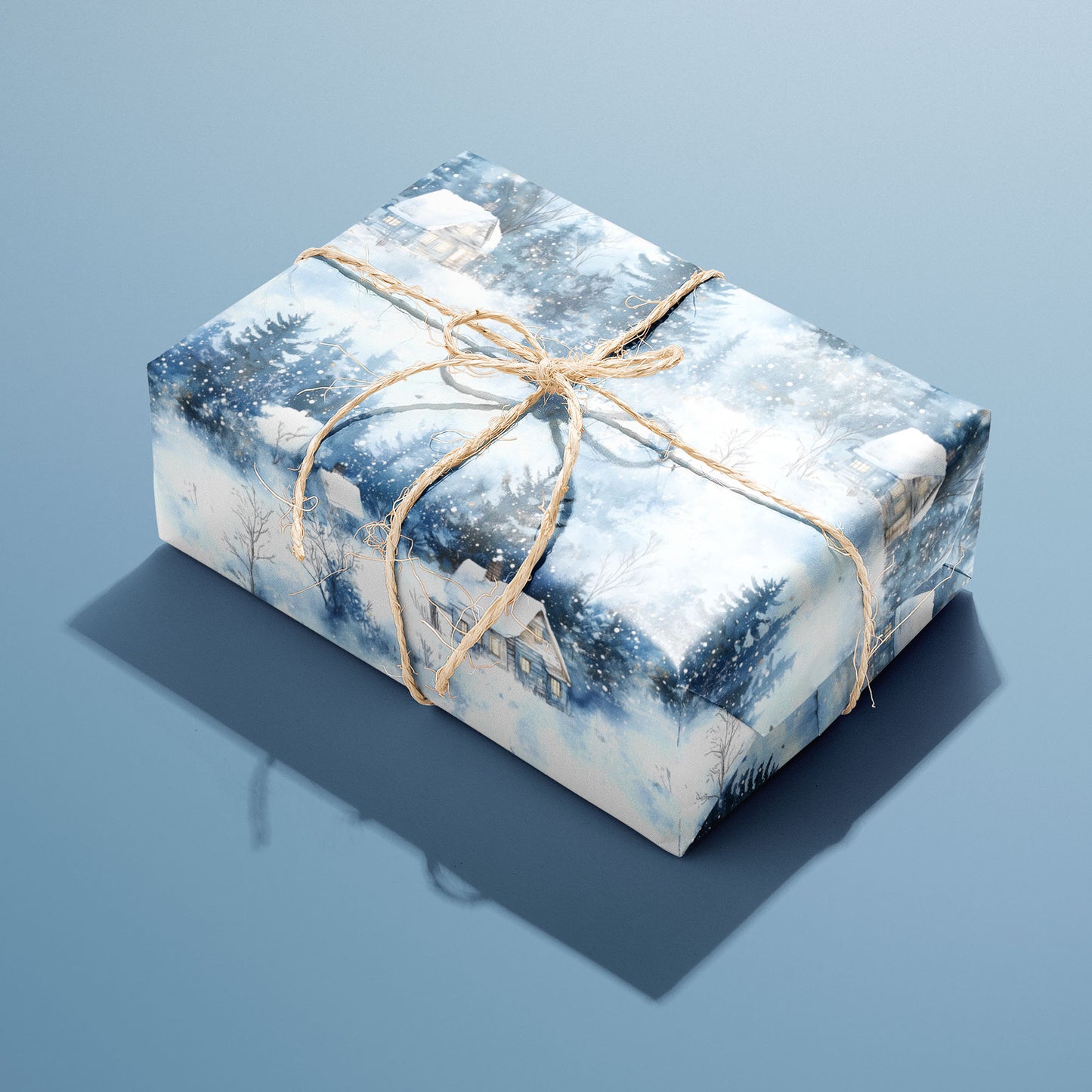 A single rectangular gift wrapped in Winter's Calm paper—watercolor cabins, pines, and snowfall—tied with natural twine on a dusty blue background.