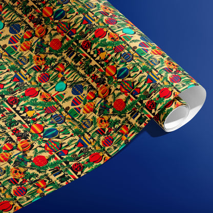 A partially unfurled roll of Retro Ornament Celebration gift wrap displaying bold striped and patterned ornaments with greenery on cream paper against a rich blue surface.