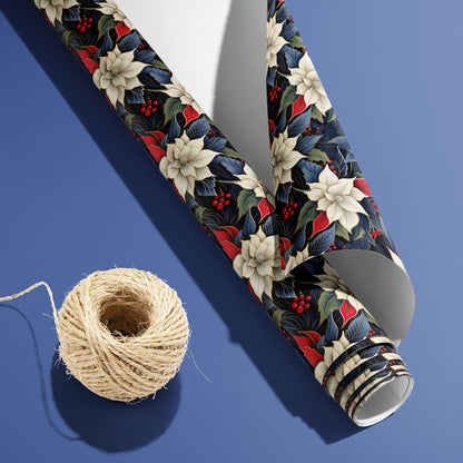 A curled roll of Elegant Poinsettias wrapping paper revealing its white underside beside a spool of natural twine on a cool periwinkle blue background.
