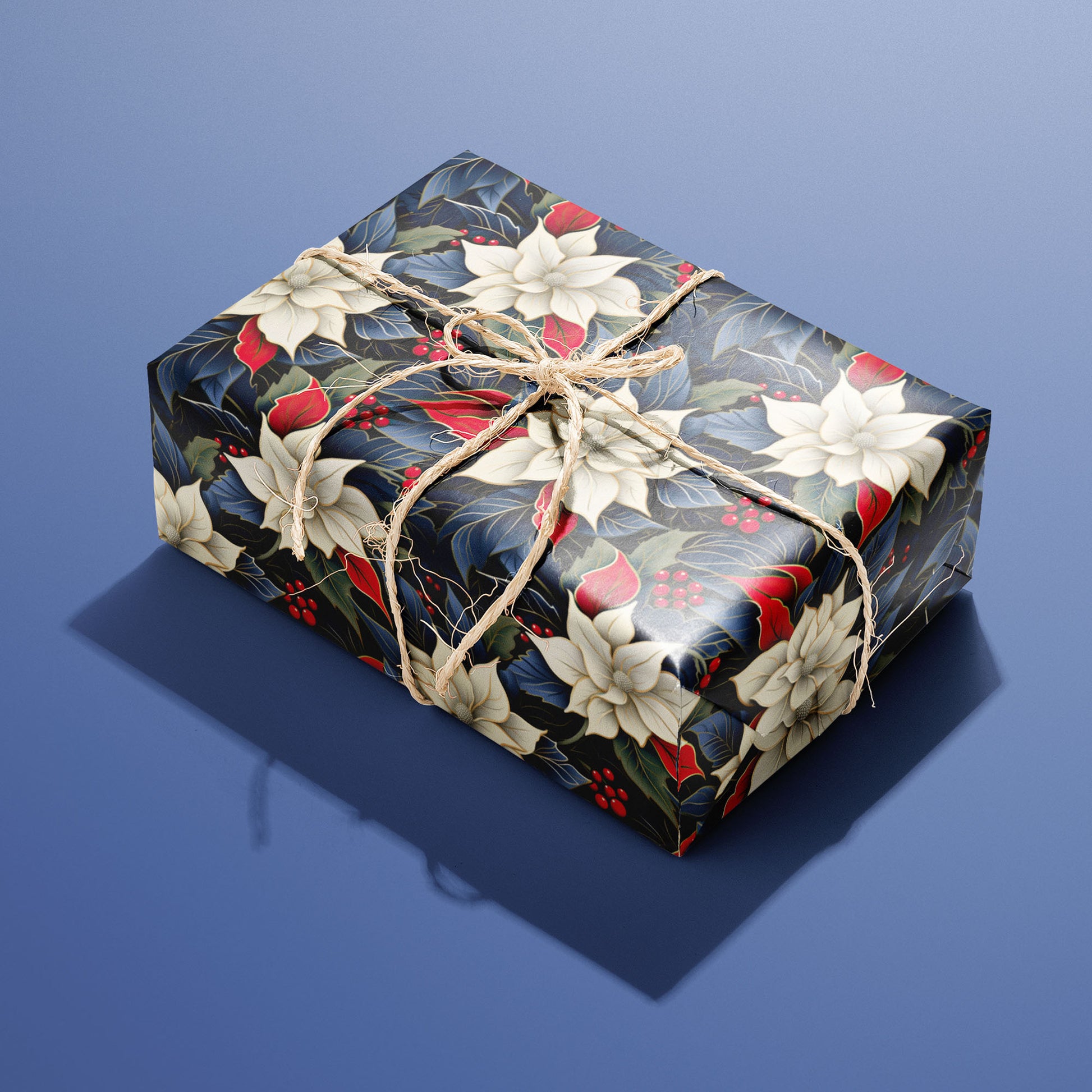 A single box wrapped in Elegant Poinsettias paper, decorated with lush ivory poinsettias and red berries and tied with rustic twine on a blue backdrop.