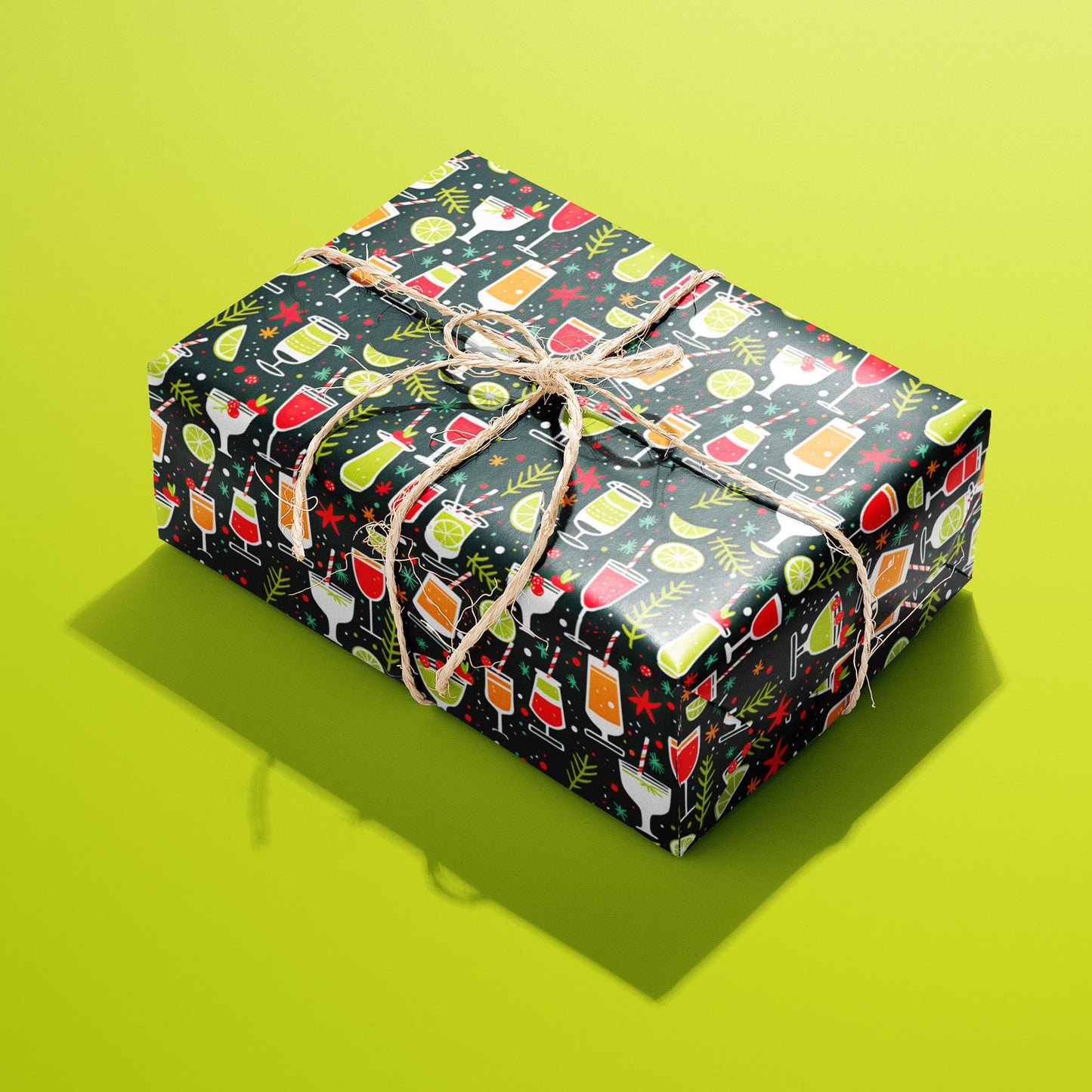 A single box wrapped in Christmas Cocktails paper, covered in playful festive drink motifs and tied with rustic twine on a lime green backdrop.