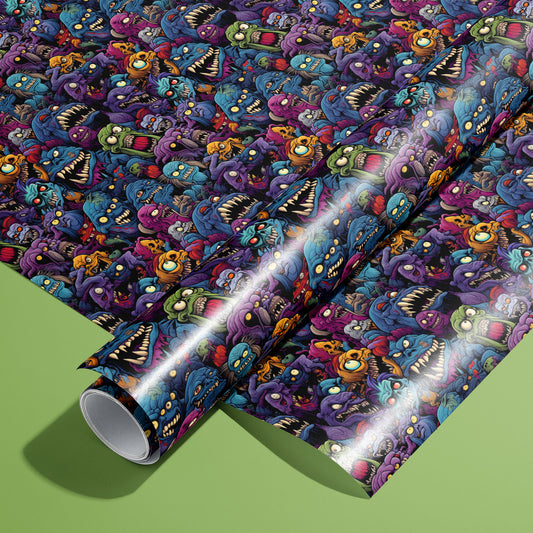 A roll of Odd Monsters rests on an unrolled sheet, showing cartoon creatures with fangs, single eyes, and tentacles in vivid hues on a dark ground, styled on an olive green surface.