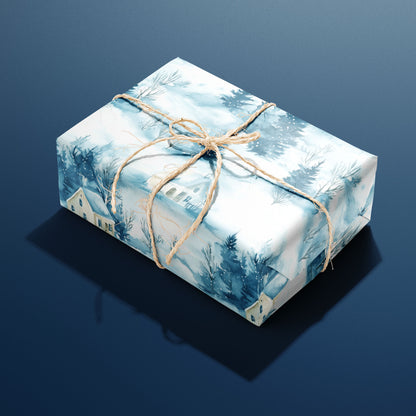 A single box wrapped in Cozy Cottage paper, illustrated with misty blue forests and winter cottages and tied with rustic twine on a navy backdrop.