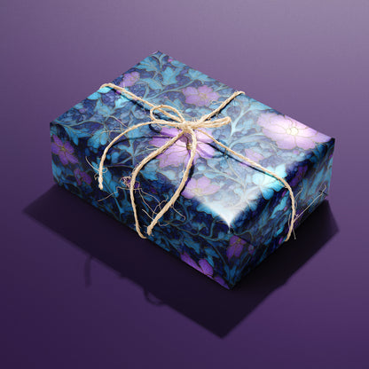 A single gift wrapped in Lunar Hellebore and tied with natural twine, featuring violet hellebore flowers and teal leaves on midnight blue, set on a deep purple surface.
