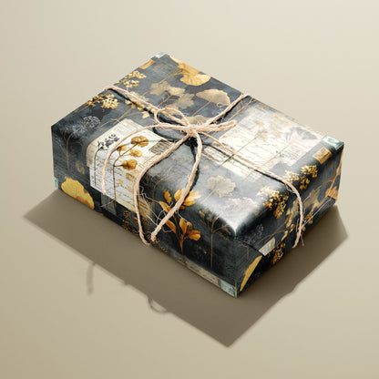 A single rectangular gift wrapped in Night Specimens paper—golden botanicals and antique labels on deep charcoal—tied with natural twine on a warm tan background.